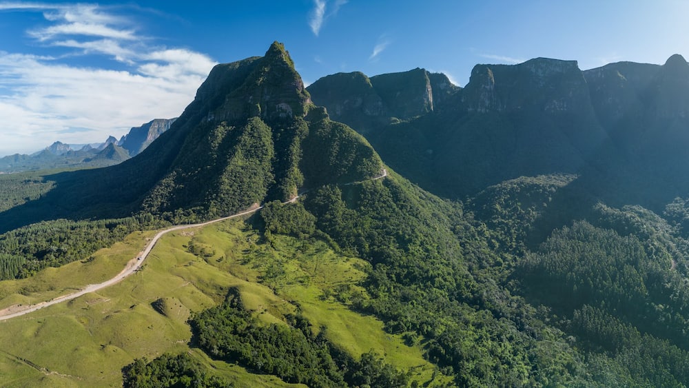 Panorama of the mountains in Brazil. Mountain range in the state of Santa Catarina, place named Serra do Corvo Branco with curved road leading up through the mountain pass