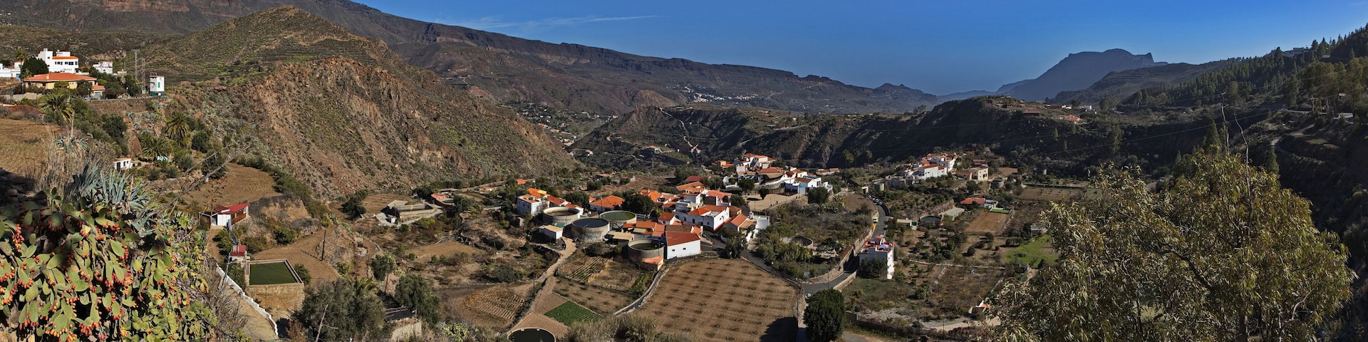 A mountainous village with terraced fields and traditional houses.