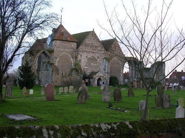 A historic church with a graveyard in front.