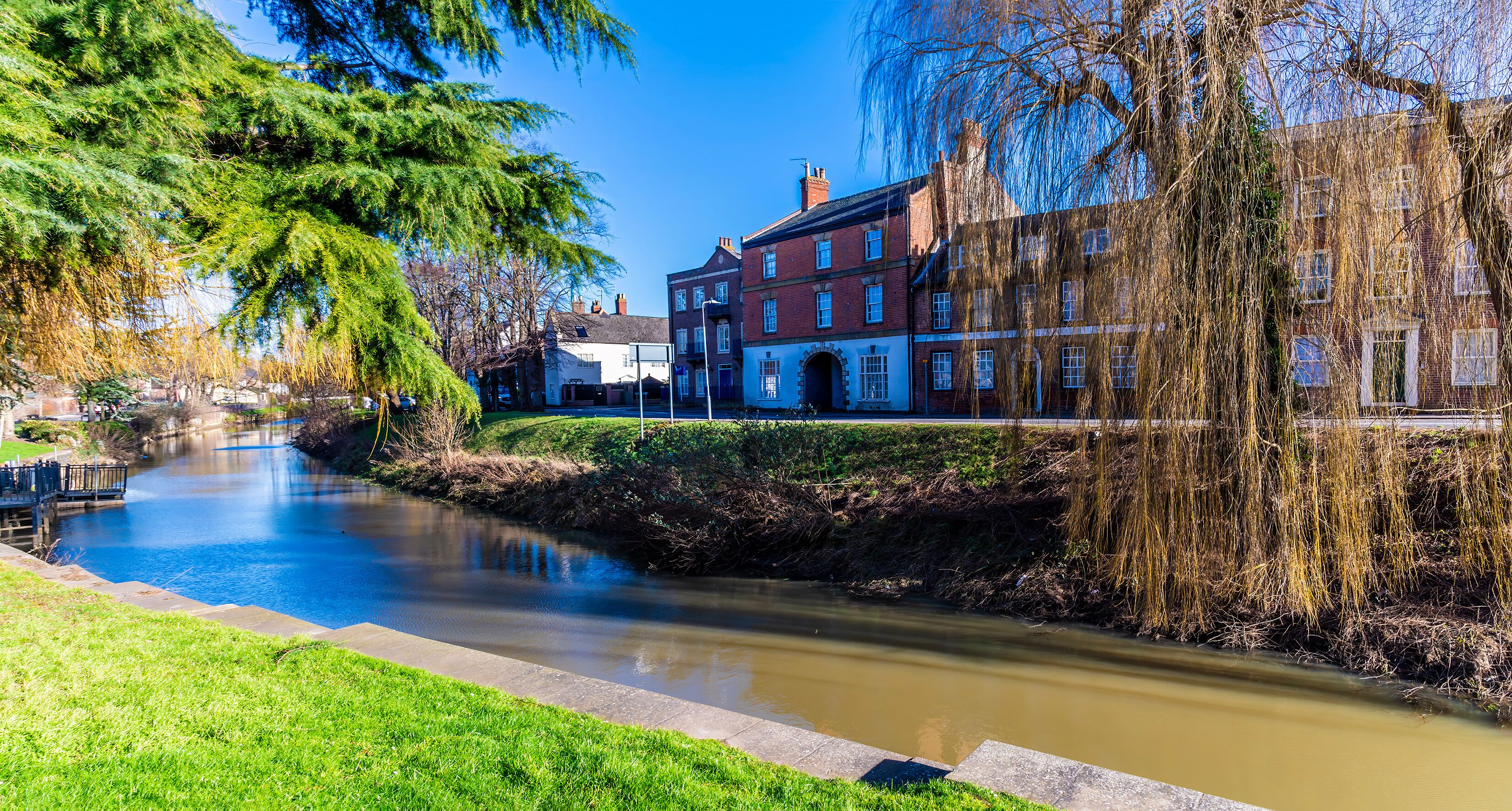 A view beside the Church Street bridge across the River Welland in the centre of Spalding, Lincolnshire on a bright sunny day