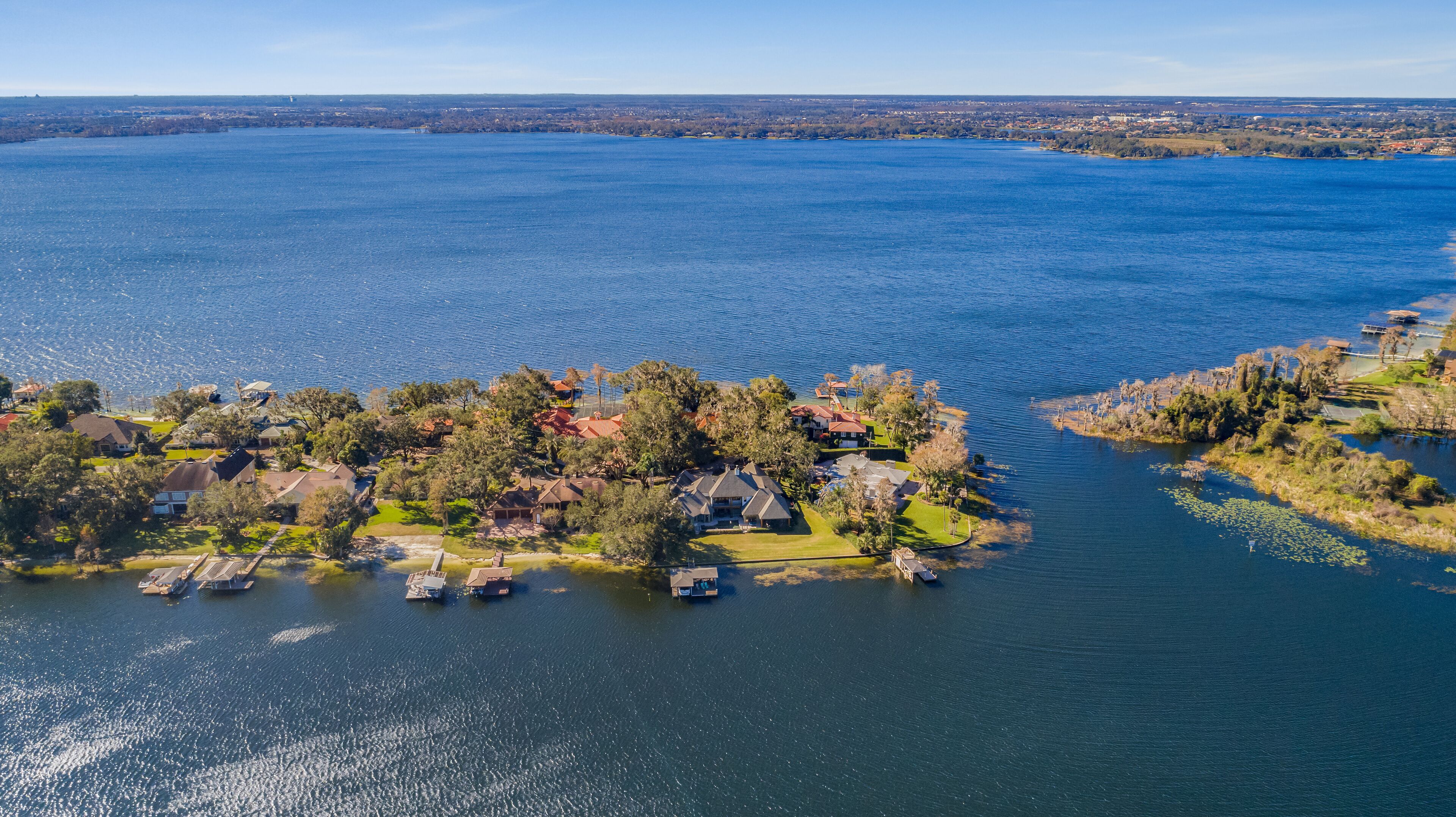 A lakeside community with houses and boats.
