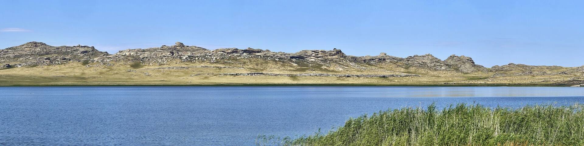 Beautiful summer steppe landscape and Ayr (Monastyri) Lake, located in stone mountains "Monasteries" and "Aiyrtau" (1003 meters above sea level), near the town of Ust-Kamenogorsk in East Kazakhstan