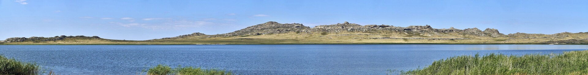 Beautiful summer steppe landscape and Ayr (Monastyri) Lake, located in stone mountains "Monasteries" and "Aiyrtau" (1003 meters above sea level), near the town of Ust-Kamenogorsk in East Kazakhstan