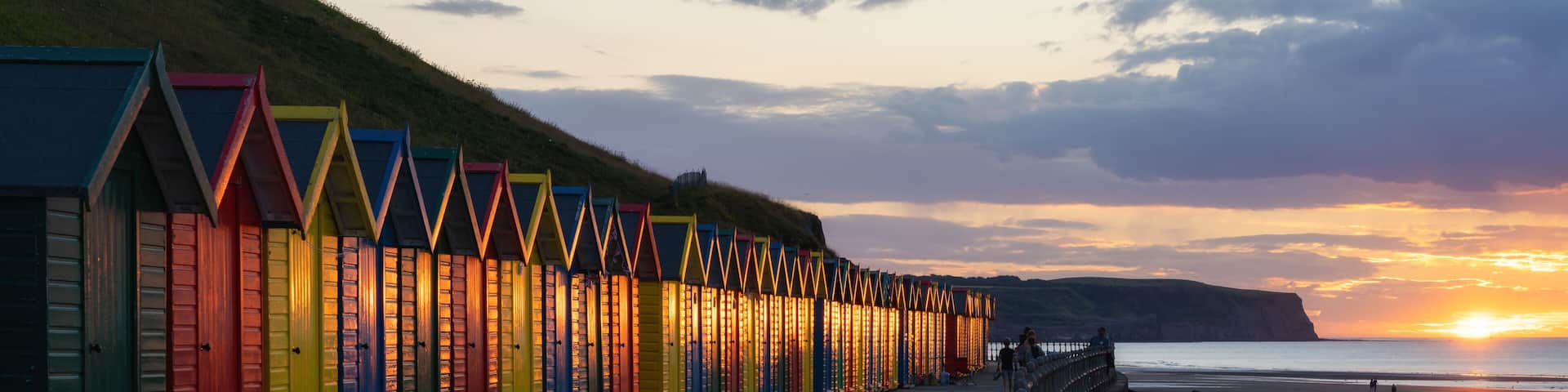 Beach huts at sunset, Whitby, North Yorkshire, England, United Kingdom