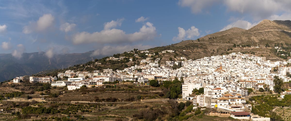 panorama view of a whitewashed village in the hills above Malaga in the Andalusian backcountry