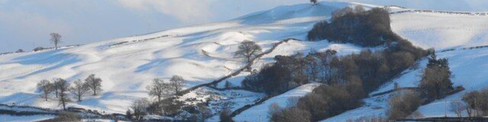Cefn Vastre The tree on the top of the ridge is almost on the north-south gridline and is marked on the map in the NE corner of the square. So there are parts of at least four squares visible in this photo. There is a farm out of shot to the right called Cefn-y-faesdre which is undoubtedly better Welsh spelling but another property in that direction is Bronyvastre and a farm out of shot to the left is Cefyn-vastre while the roof at the bottom of the picture is on the Vastre Industrial Estate so V wins over F on this occasion. Viewed from Barn Lane.