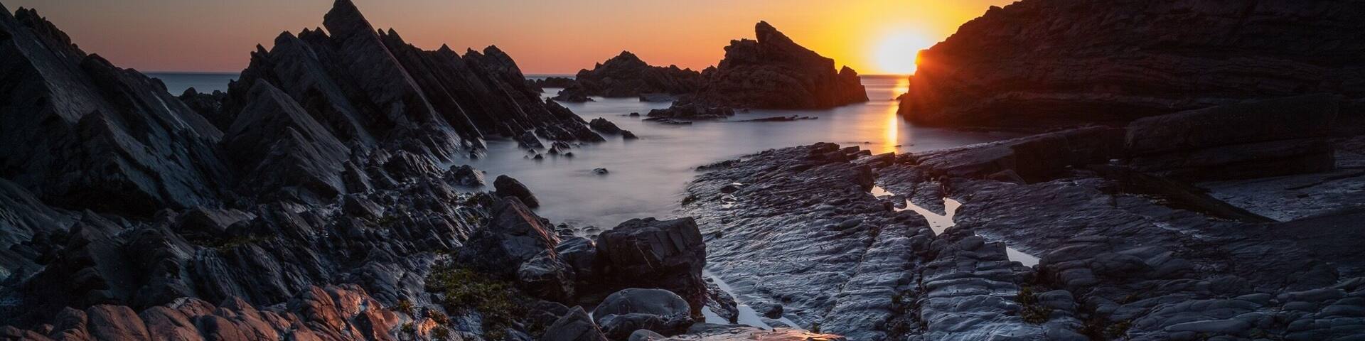 Sun down and tide out at Hartland Quay