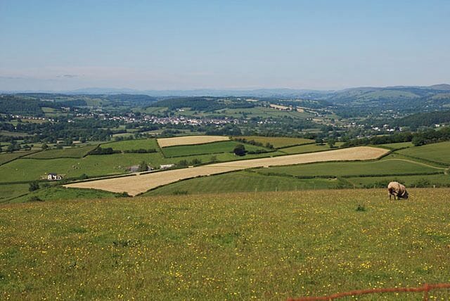 Fields northwest of Derlwyn farm Dropping off the high ground. Lampeter lies in the distance.