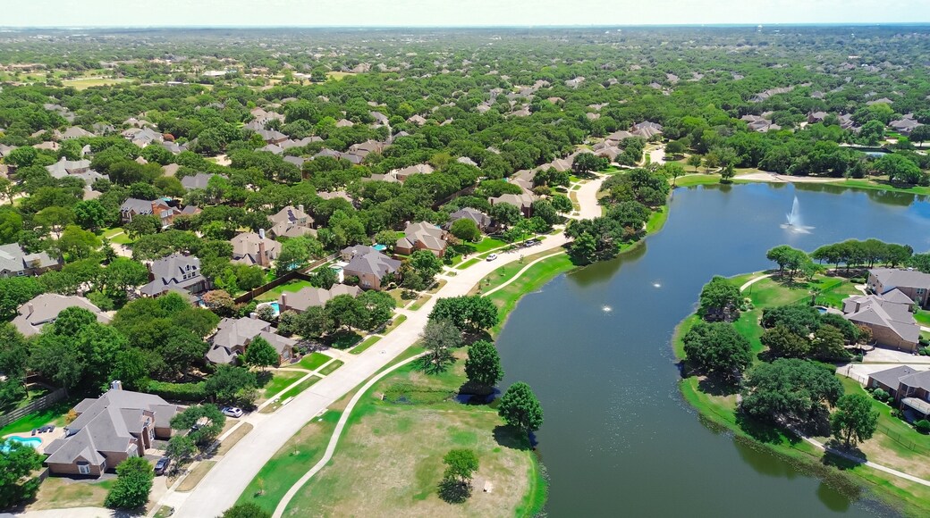 Neighborhood pond park with walking pathway trail in upscale lakeside residential area, two-story new development houses, urban forest mature trees, Keller, Tarrant County, suburbs Dallas, aerial