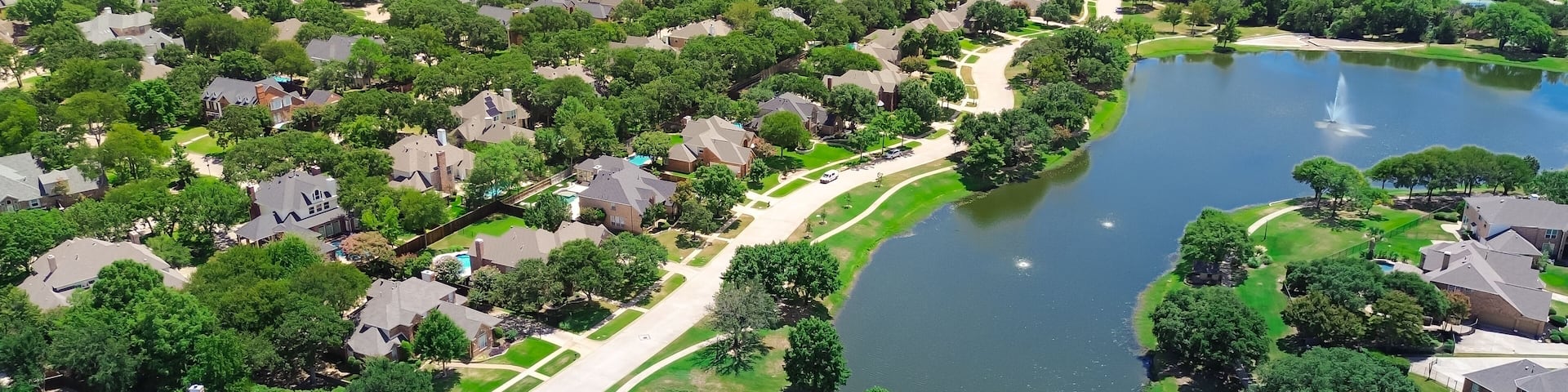 Neighborhood pond park with walking pathway trail in upscale lakeside residential area, two-story new development houses, urban forest mature trees, Keller, Tarrant County, suburbs Dallas, aerial