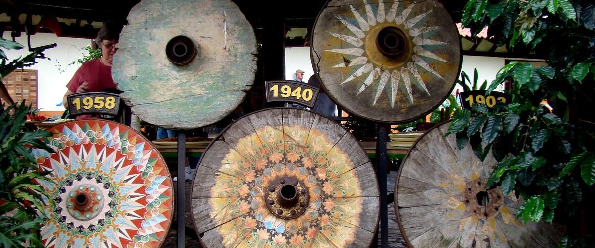 A row of large, ornate umbrellas with numbers 1895, 1901, 1958, and 1940 displayed above them.