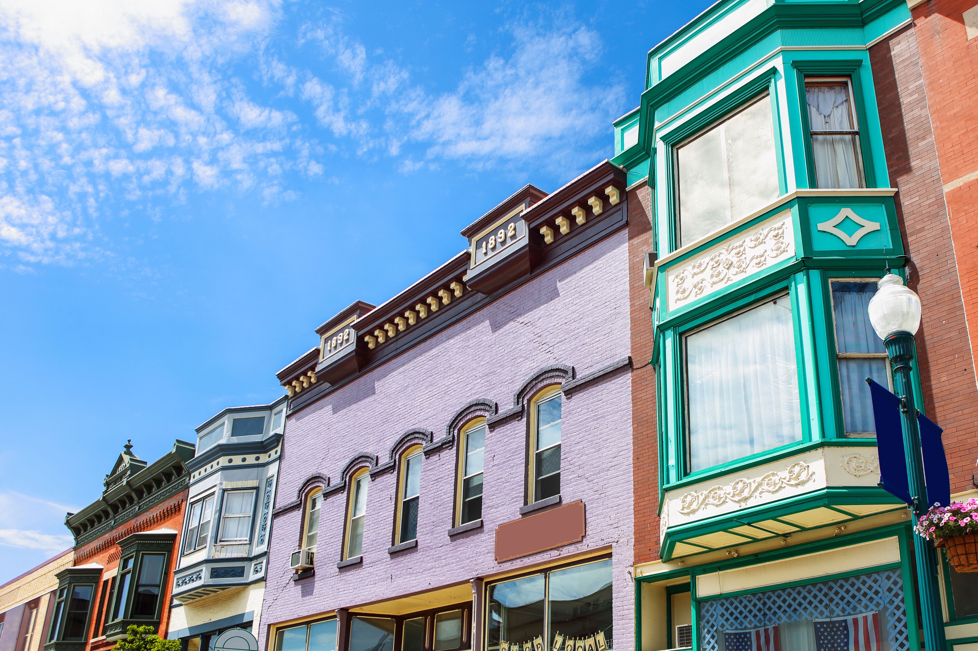 A row of colorful Victorian-style buildings with distinct architectural details.