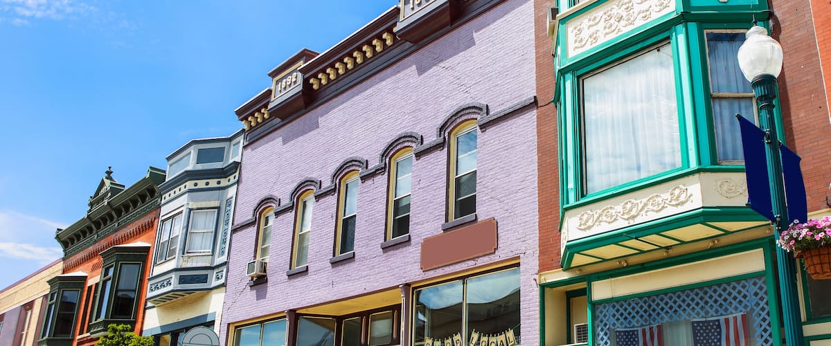 A row of colorful Victorian-style buildings with distinct architectural details.