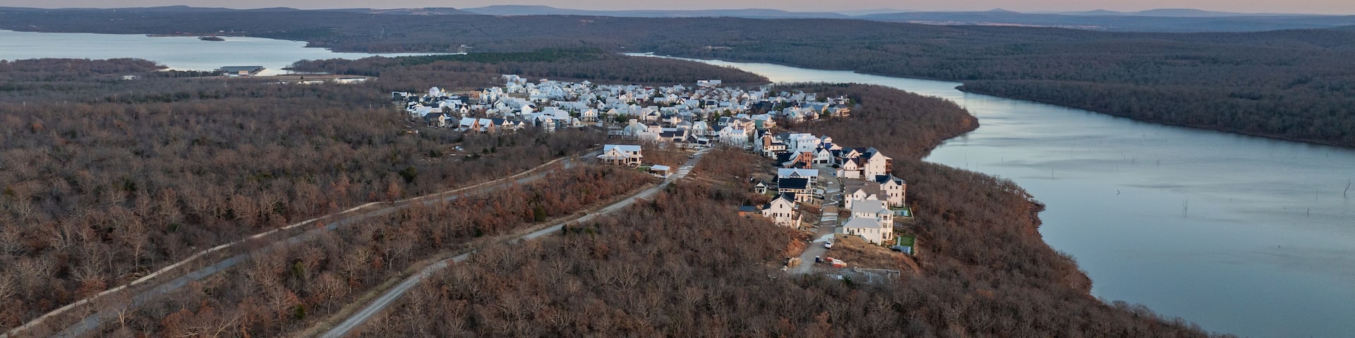 Panoramic view of lakeside houses and homes in Carlton Landing, Oklahoma resort town on Eufaula Lake during sunset with surrounding landscape