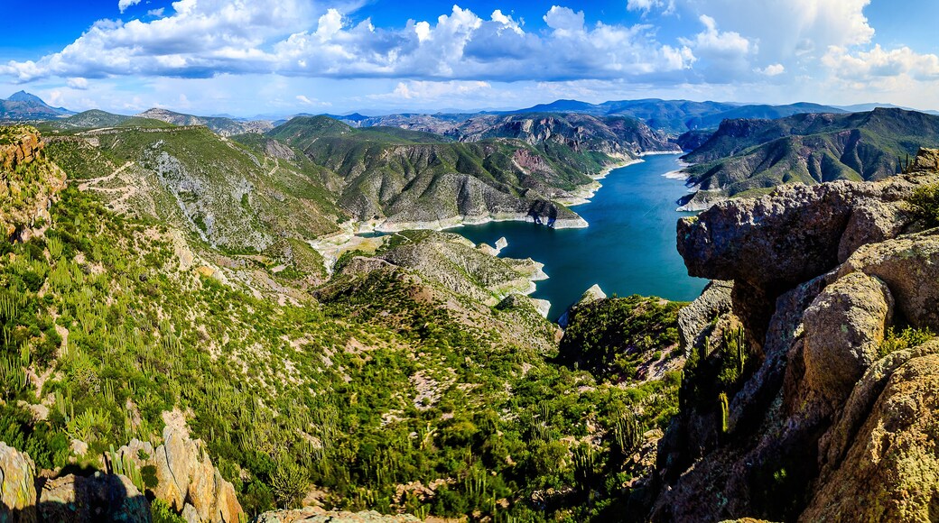 horizontal panoramic of lake in middle of the valley surrounded of mountains with green hills in sky with clouds in zimapan hidalgo