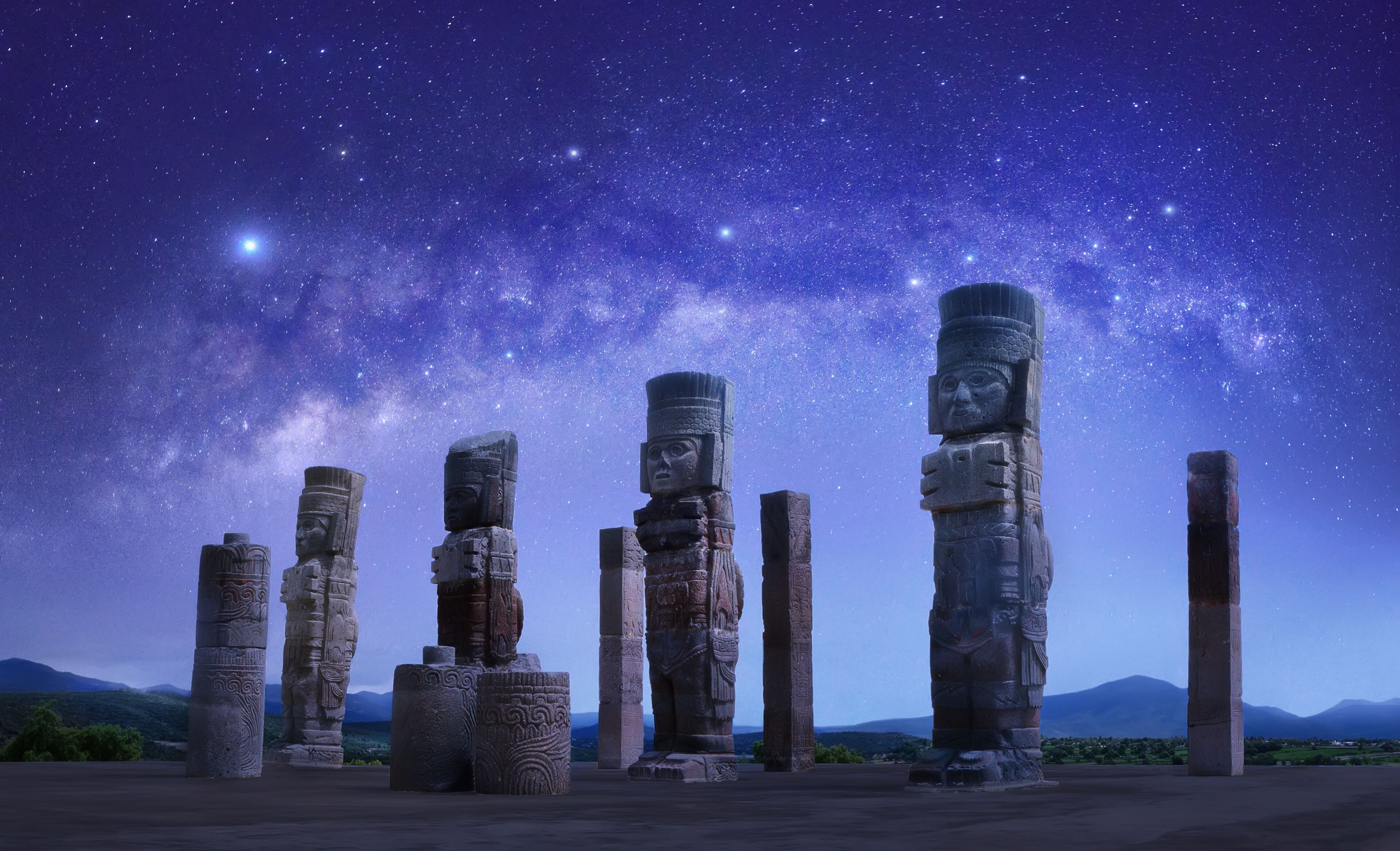 Toltec sculptures in Tula against background of starry sky, Mexico