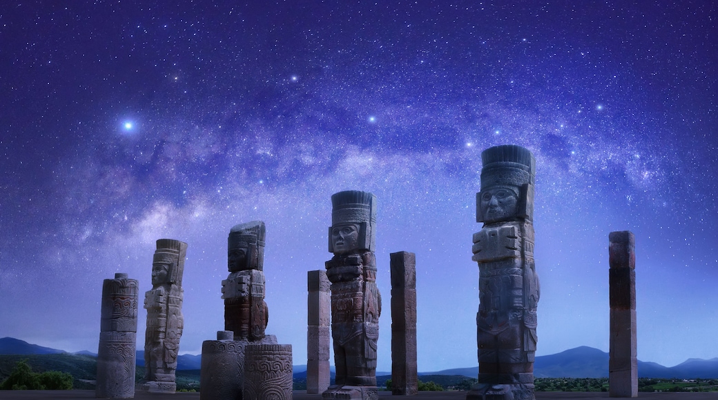 Toltec sculptures in Tula against background of starry sky, Mexico