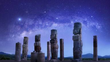 Toltec sculptures in Tula against background of starry sky, Mexico