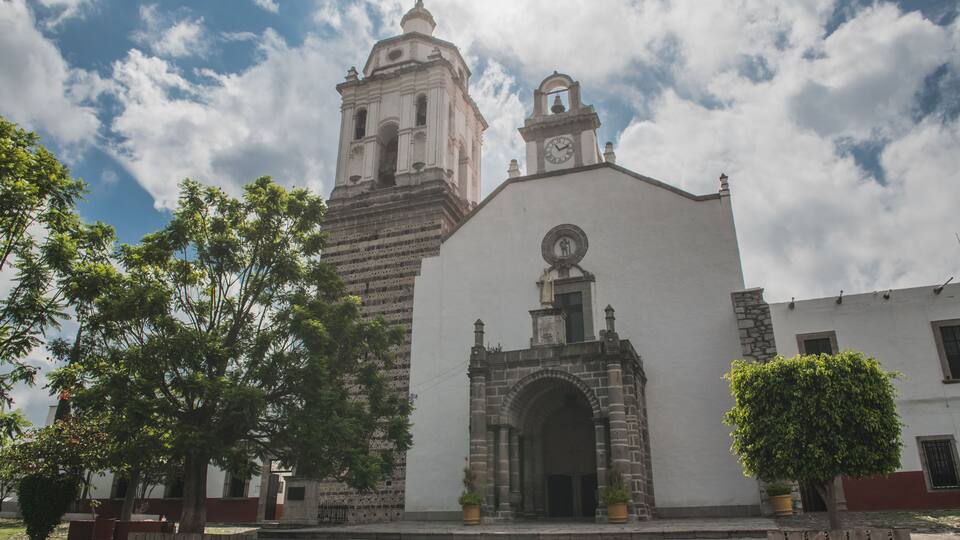 A historic church with a bell tower and a large arched entrance.