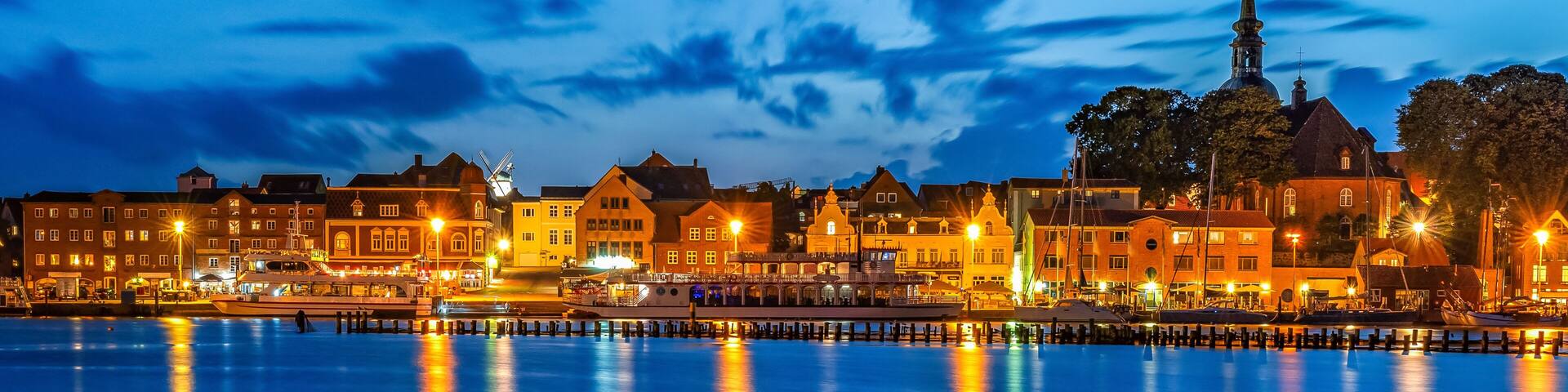 View to the skyline of small city of Kappeln in Germany at blue hour