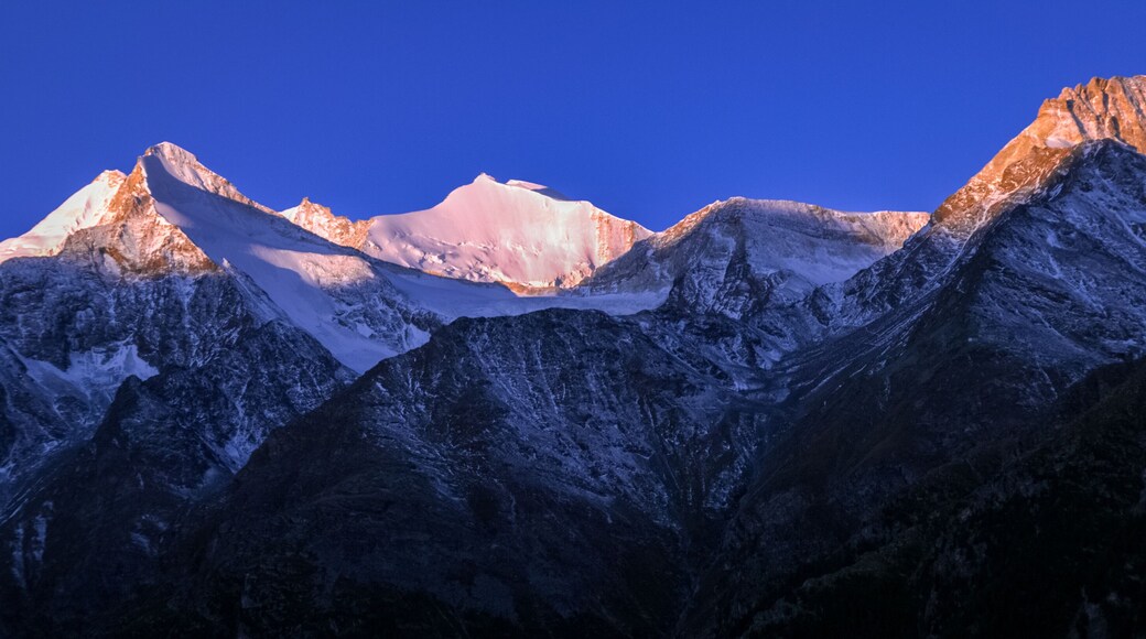 Mountains surrounding Grachen on a clear autumn morning during sunrise (Valais, Switzerland). The village is situated at an altitude of 1,620 meters on a terrace above St. Niklaus in the Mattertal