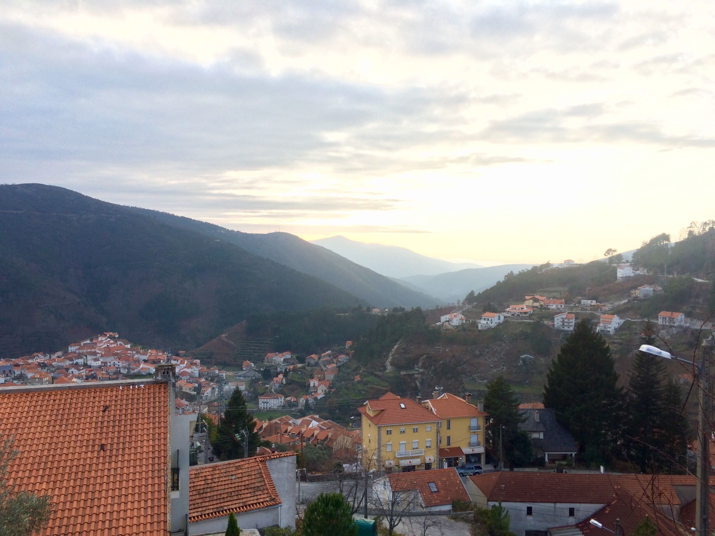 A mountainous landscape with a village nestled in the valley.