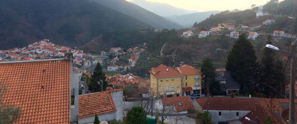 A mountainous landscape with a village nestled in the valley.