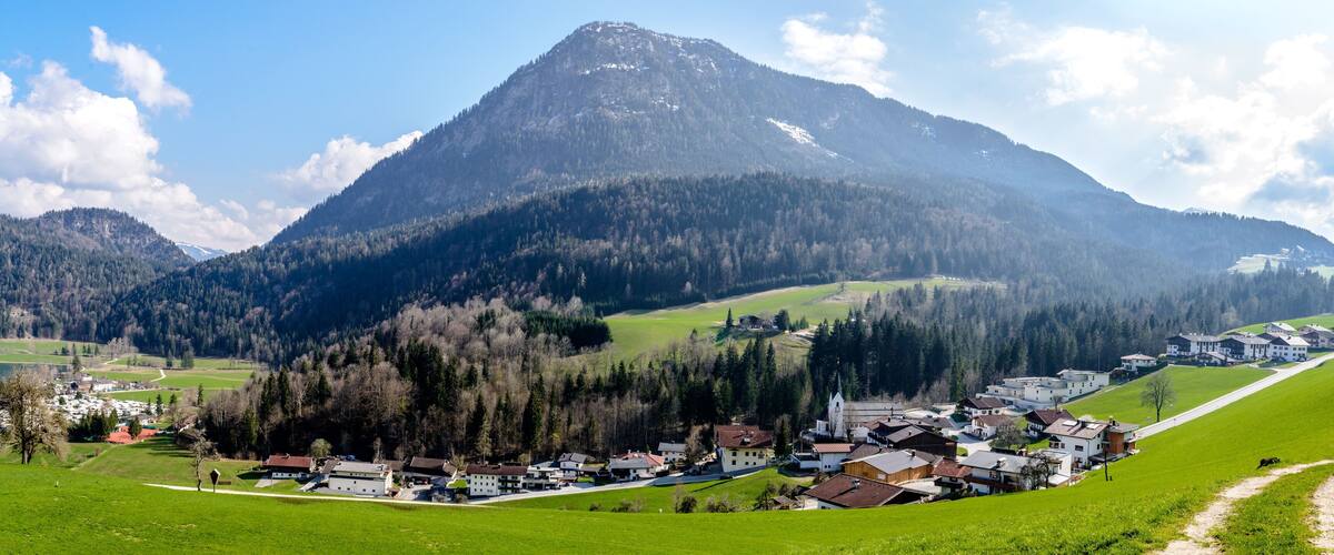 A mountainous landscape with a village nestled at its base.