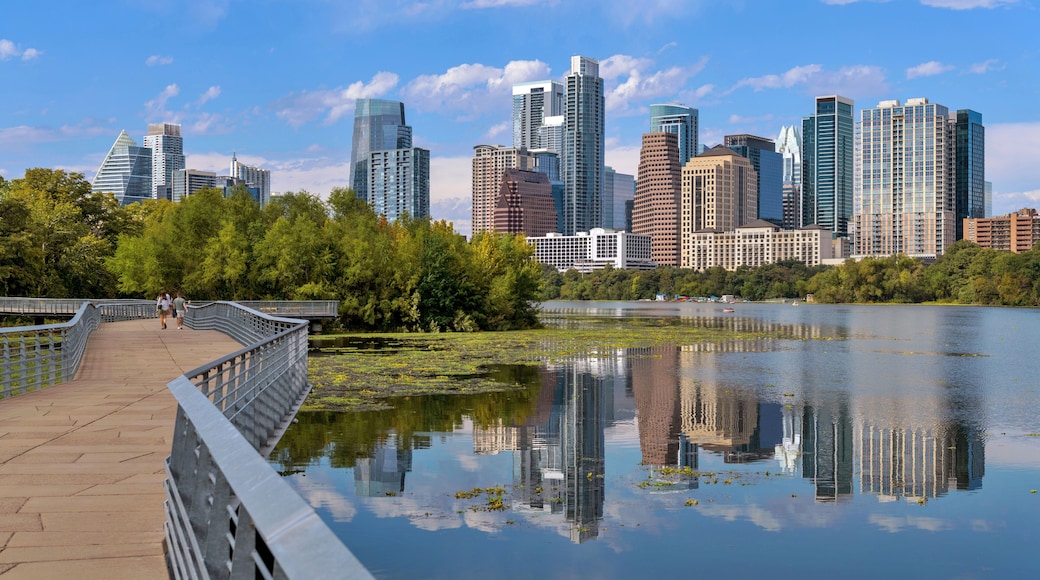 Lake Boardwalk - A panoramic view of the boardwalk of Ann and Roy Butler Hike-and-Bike Trail at Lady Bird Lake, with modern skyscrapers towering in background, on a sunny Autumn day. Austin, Texas, US