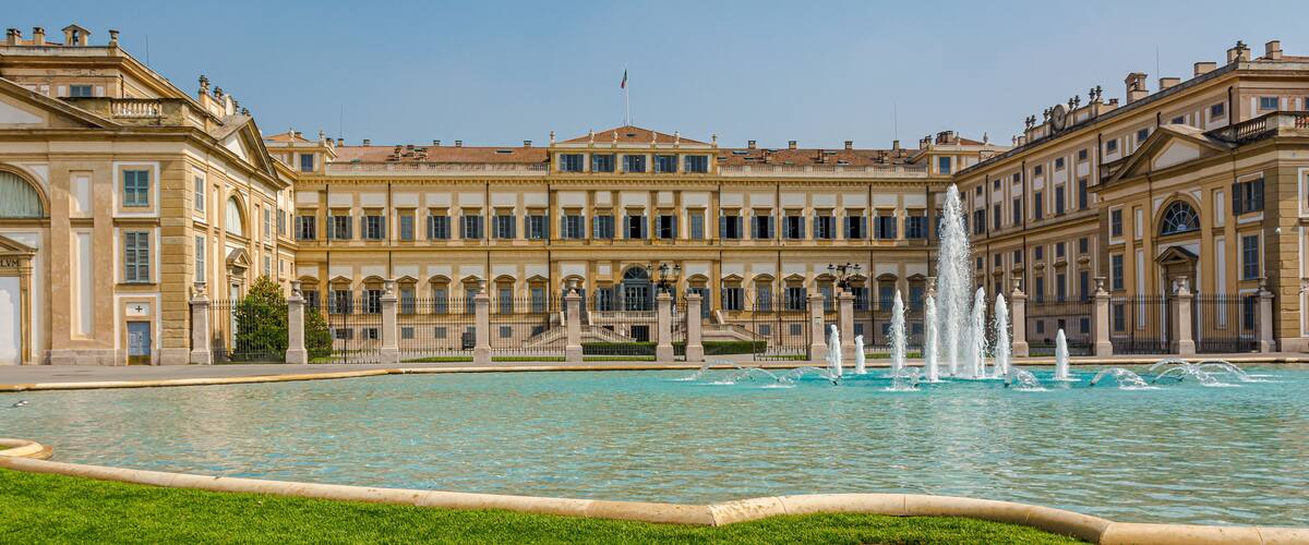 A grand building with a fountain in front.