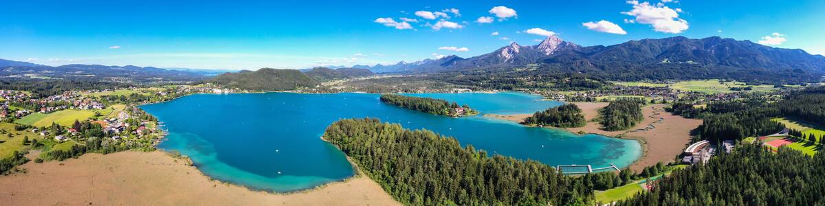 Faaker See in Carinthia. Aerial view to the beautiful lake and the Mittagskogel mountain in the south of Austria.
