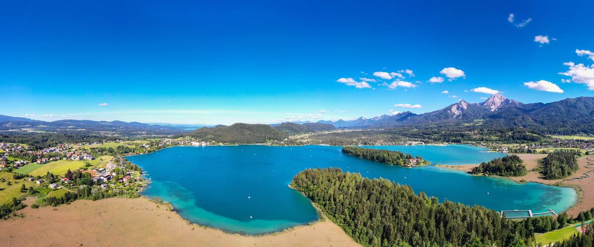 A lake surrounded by mountains and a small town.