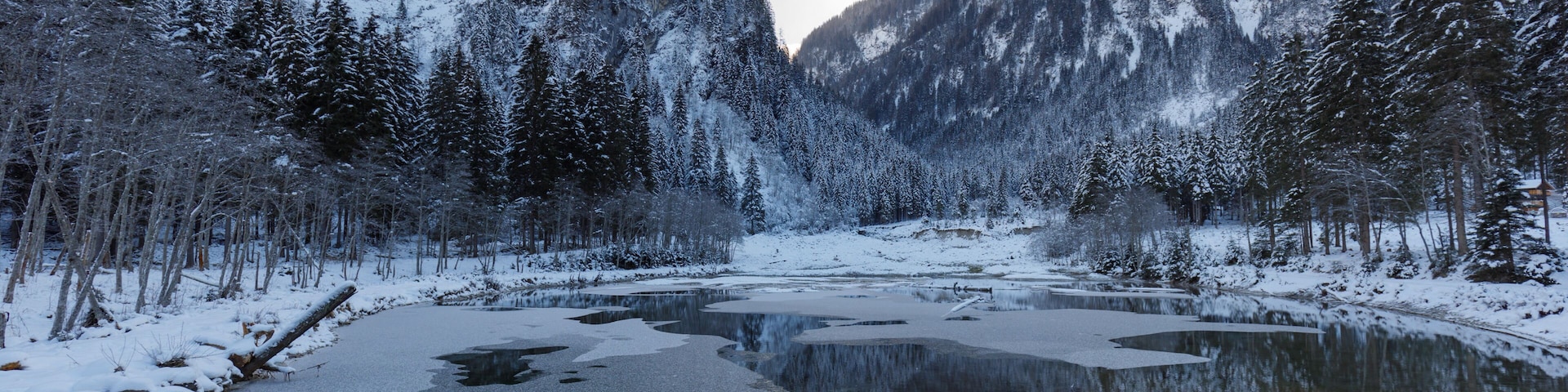 ötzlsee in valley großarl in austria in winter, partly frozen on sunny day