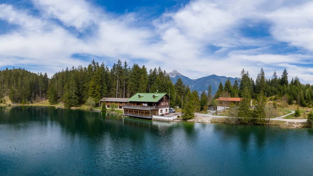 A lake surrounded by dense forest and mountains.