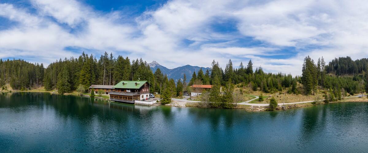 A lake surrounded by dense forest and mountains.