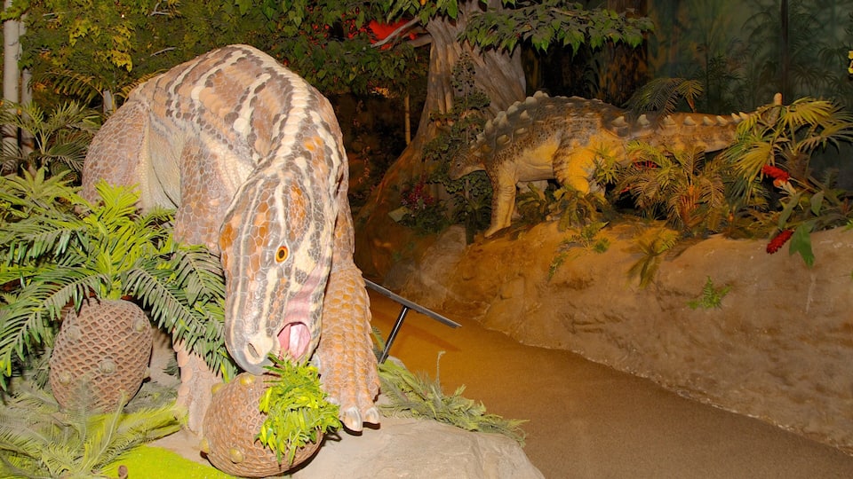 A dinosaur exhibit with a large dinosaur head and a smaller one in the background.