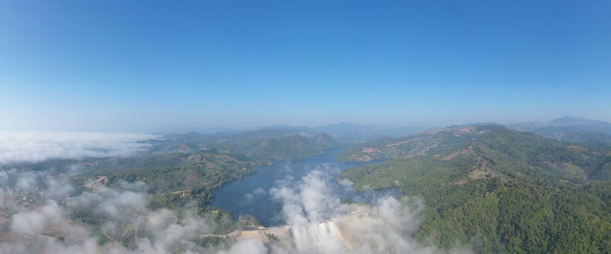 panorama landscape amazing view Mae Suai Dam or reservoir in a valley and blue sky at chiang rai Thailand, aerial view from drone for background
