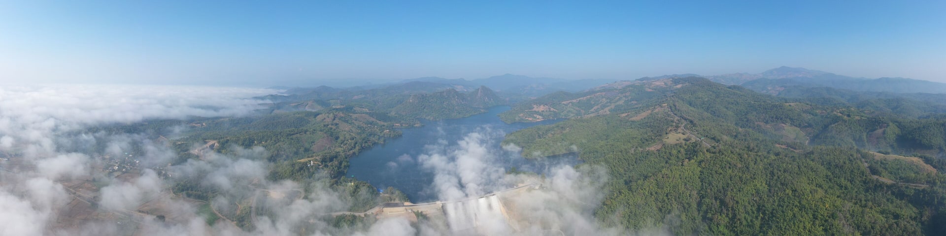 panorama landscape amazing view Mae Suai Dam or reservoir in a valley and blue sky at chiang rai Thailand, aerial view from drone for background