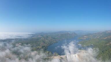 panorama landscape amazing view Mae Suai Dam or reservoir in a valley and blue sky at chiang rai Thailand, aerial view from drone for background
