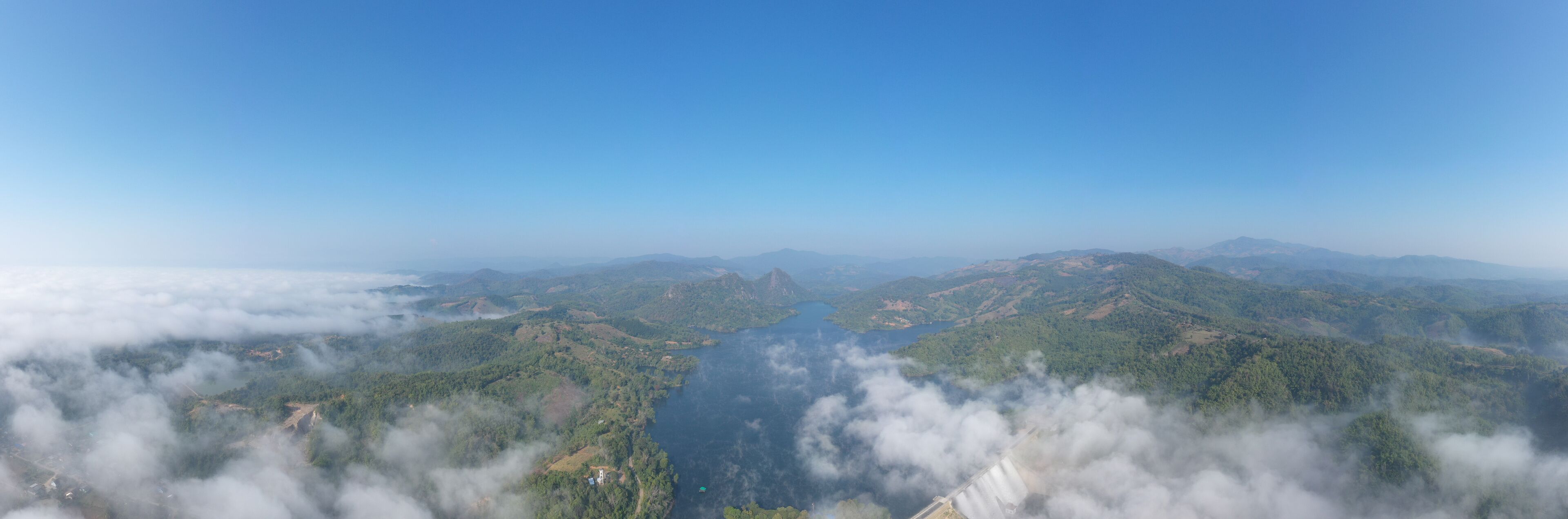 panorama landscape amazing view Mae Suai Dam or reservoir in a valley and blue sky at chiang rai Thailand, aerial view from drone for background