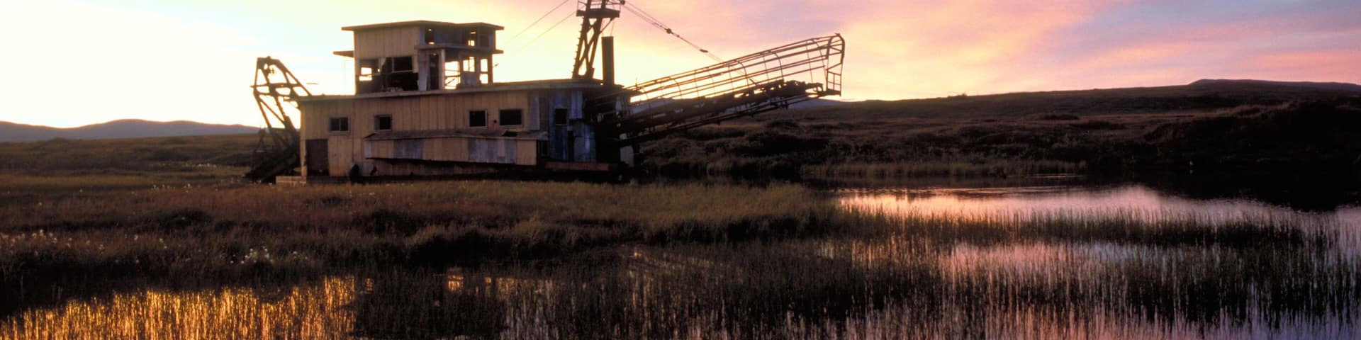 Western Alaska which includes a sunset, wetlands and tranquil scenes
