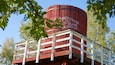 A wooden water tower with the inscription "CROOKED CREEK AND ISLAND ROAD."