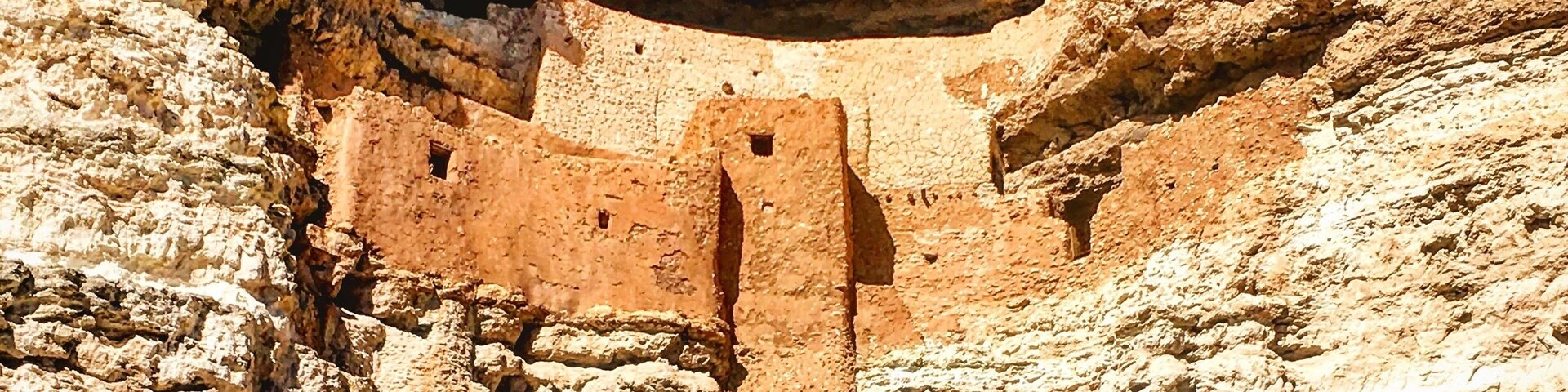 A rock formation with a cave-like structure carved into it.