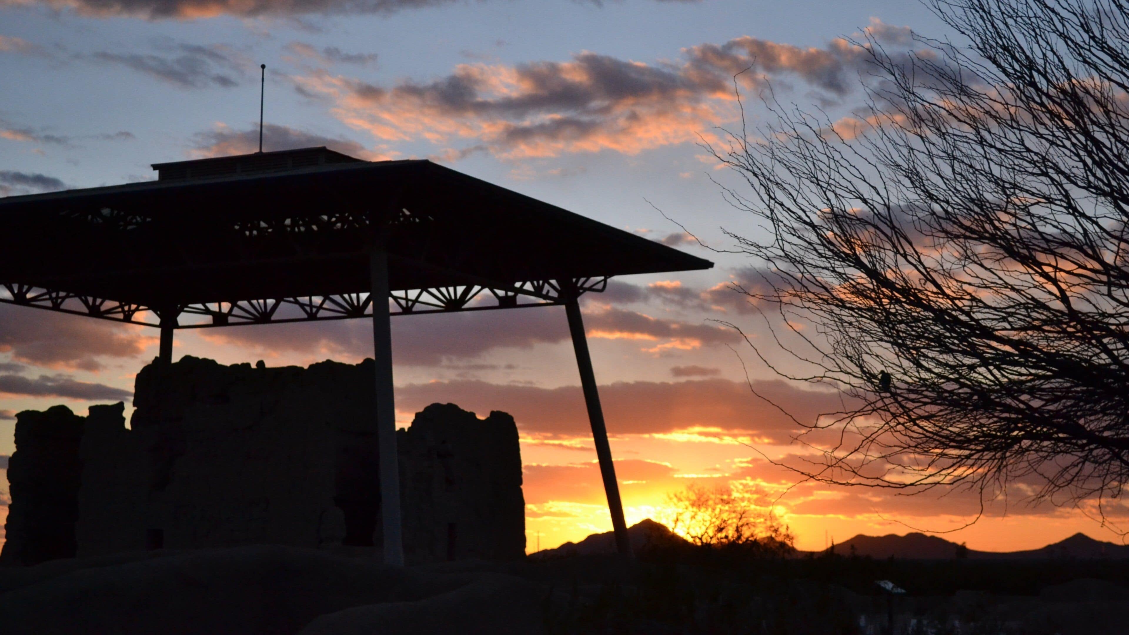 Casa Grande Ruins National Monument which includes a monument, a sunset and building ruins