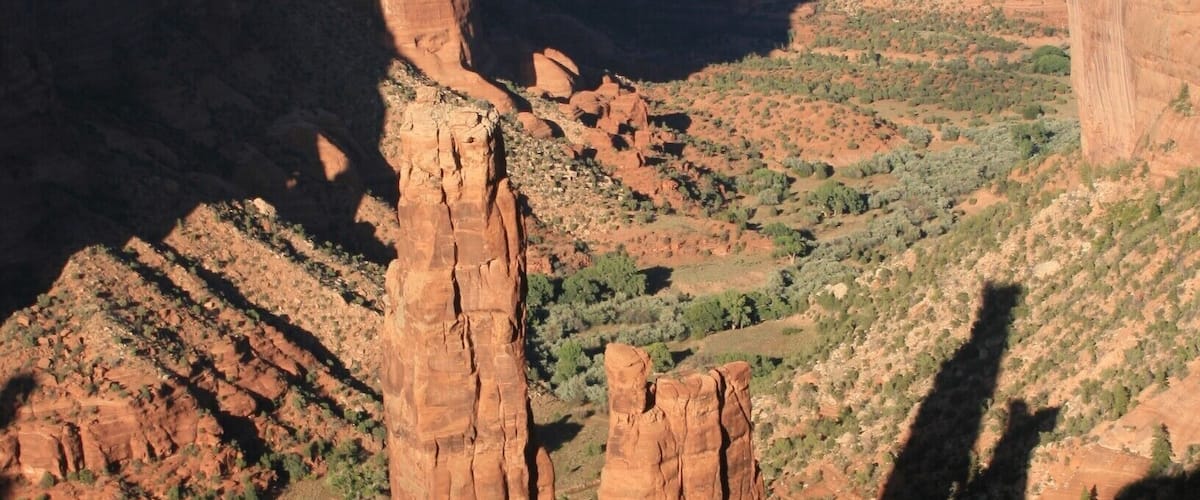 Canyon de Chelly (pronounced duh-Shay) is in the book 1000 Places to See Before You Die. Hard to get to in the northeast corner of Arizona, this 800-foot-deep Canyon is infused with the ghosts of eons of Native Americans. The steep walls of the canyons hide ruins of ancestral pueblo dwellings that make you ask, "How on earth did they GET there?" The valley of the canyon is still farmed by Native Americans today.