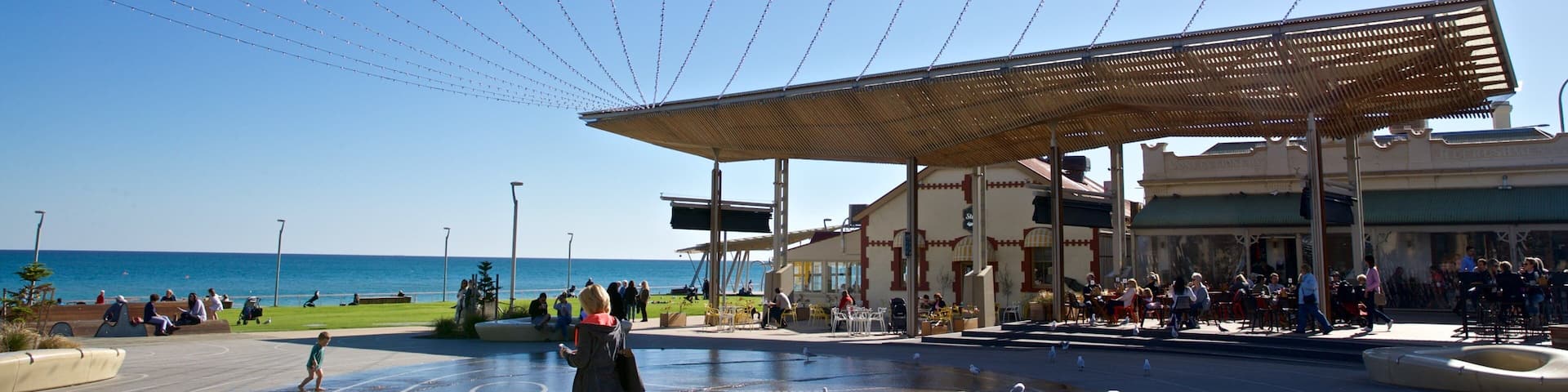 Henley Beach which includes a fountain and a square or plaza as well as a family