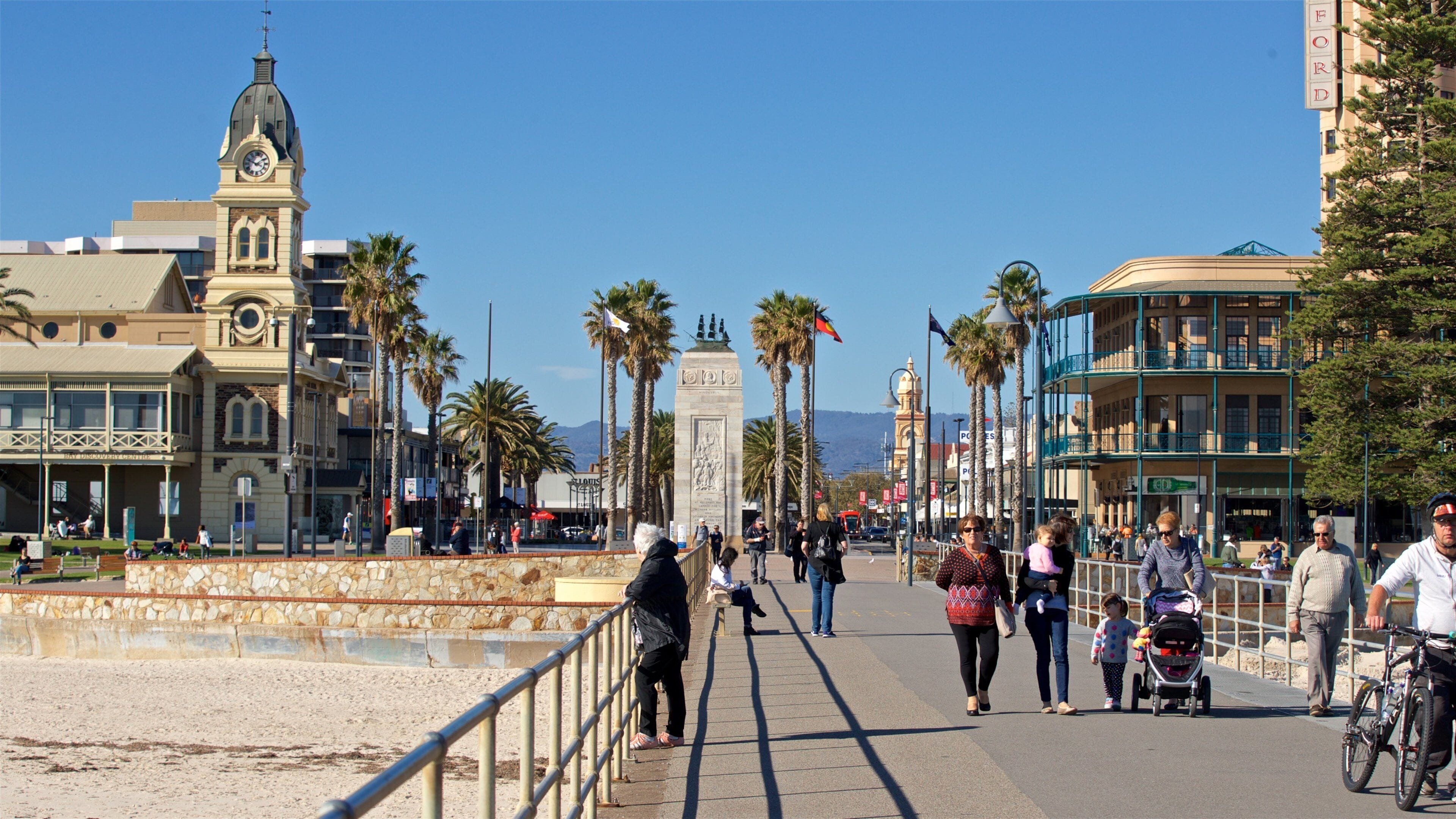 Glenelg Jetty which includes a coastal town as well as a small group of people