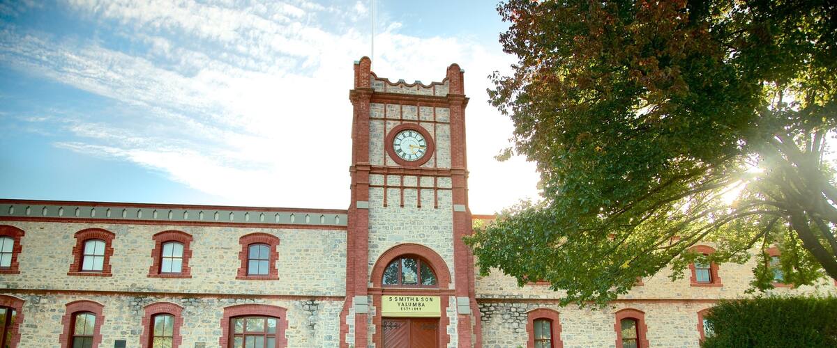 A historic building with a clock tower, stone facade, and a sign reading "S. S. Smith & Son Yalumba Established 1849".