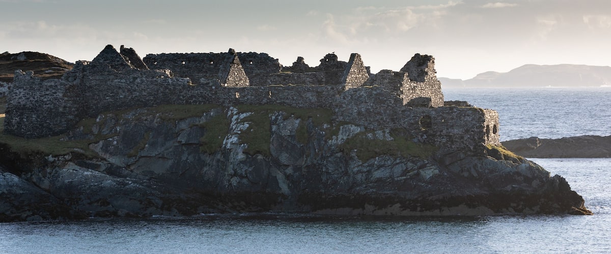 A coastal ruin on a cliff overlooking the sea.