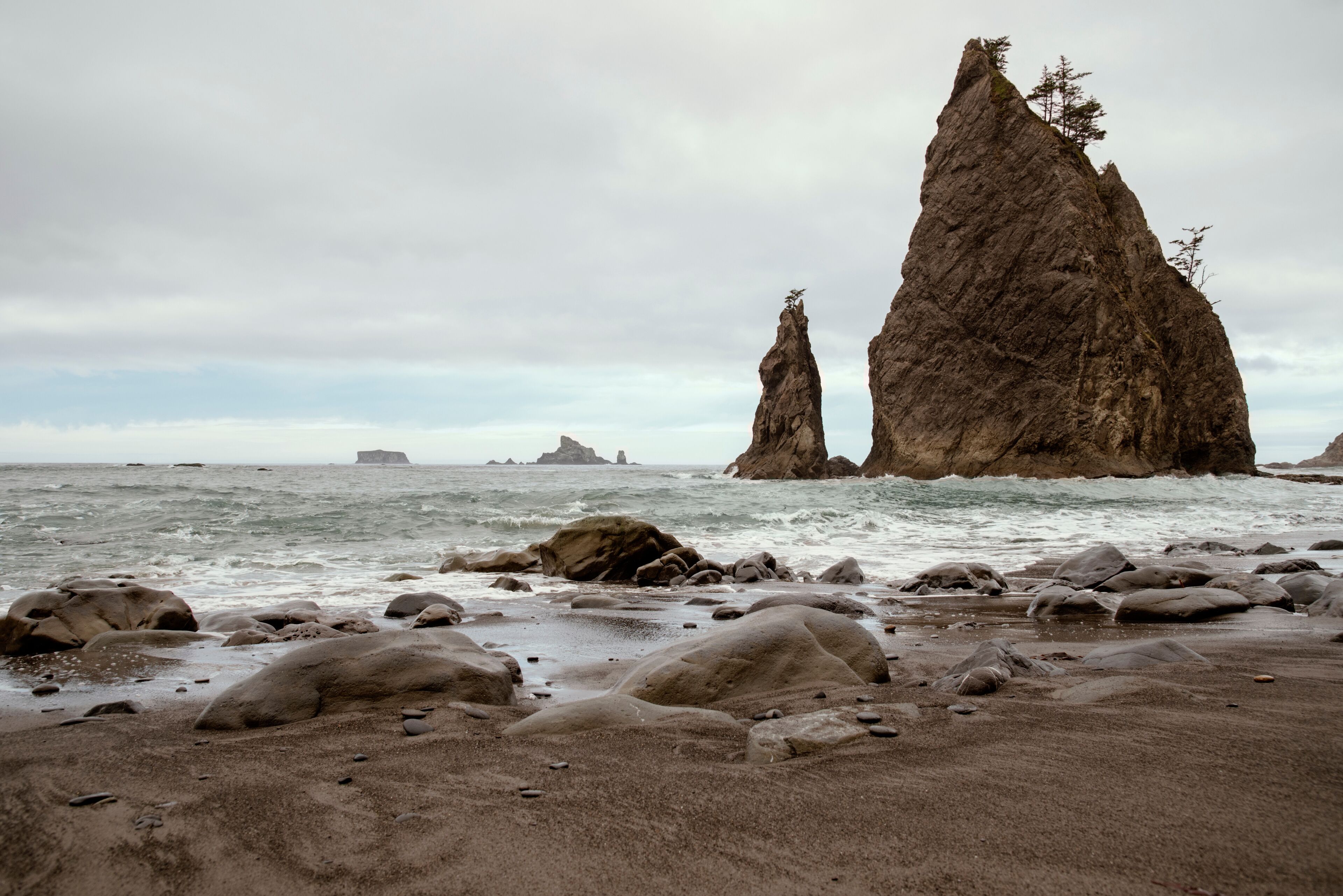 Sharp tall haystack rock formations off the Pacific coast.